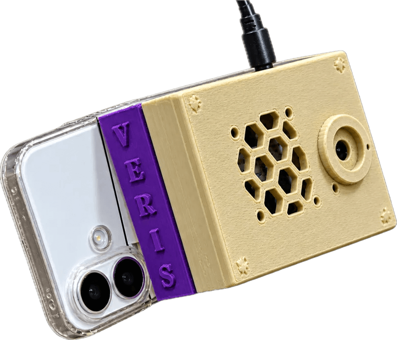 The Veris prototype, a 3D-printed unit with a camera and a vent, clipped to the back of a phone.